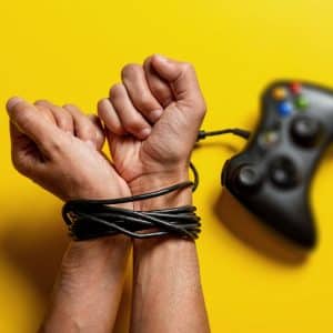 hands tied with gaming controller cable